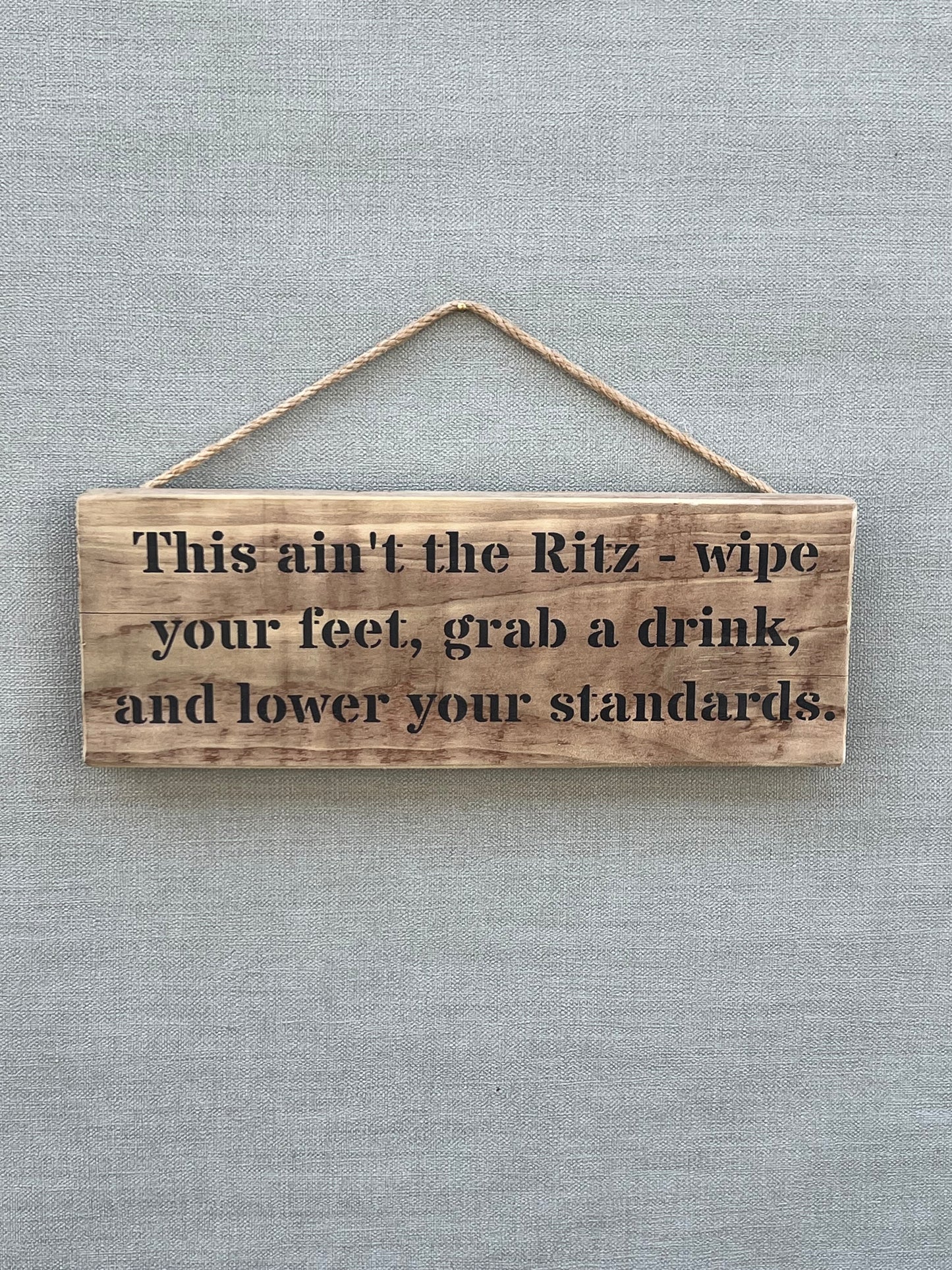 Handmade wooden sign - This ain't the Ritz - wipe your feet, grab a drink, and lower your standards.